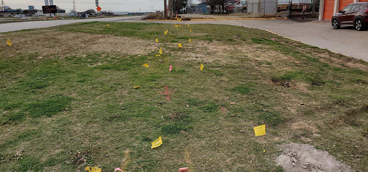 flag markings in the ground for Diamond Interchange right of way project